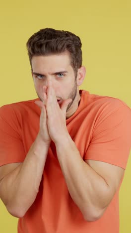 a man feeling cold and trying to warm himself by crossing his arms and blowing into his hands