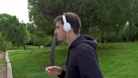 runner turns on mobile application and starts running with headphones