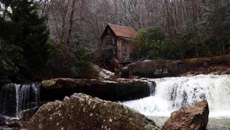 grist mill in west virginia with river flowing