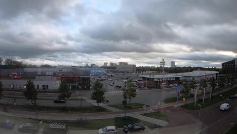 Timelapse-of-a-shopping-centre-and-intersection-in-The-Netherlands,-Groningen