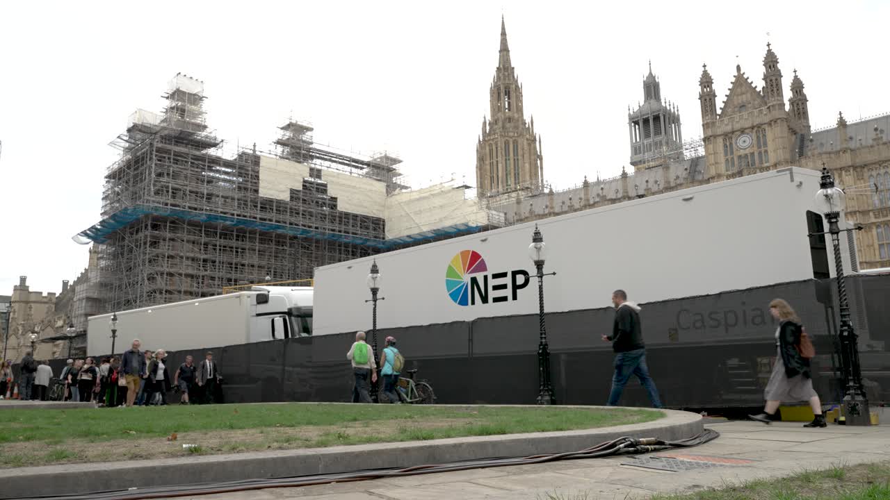 Caspian NEP OB Broadcast Truck Parked Outside Houses Of Parliament. Low Angle, Locked Off