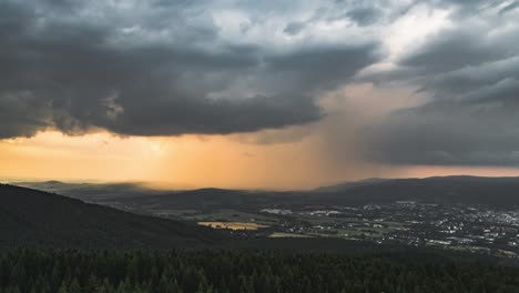 Timelapse-of-dark-and-orange-storm-clouds-before-sunset,-static-view