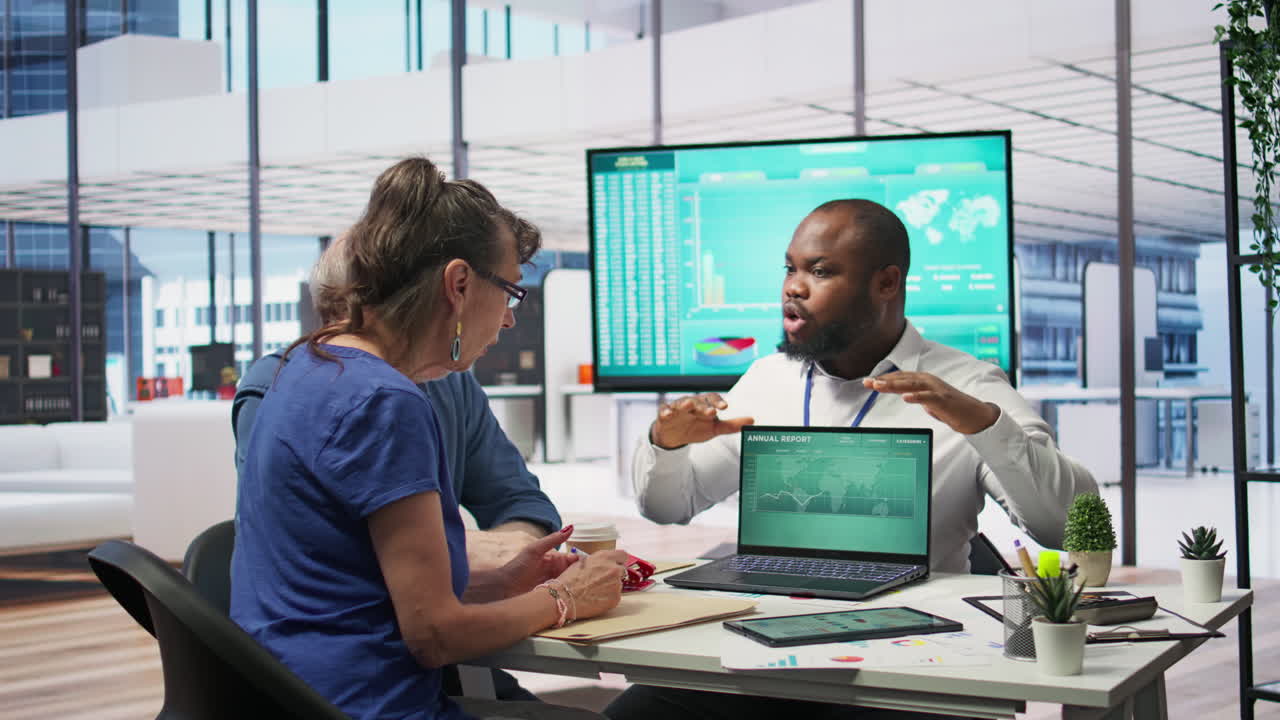Mature couple discussing retirement strategy with a financial planner