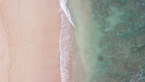 Vista-Aérea-De-Arriba-Hacia-Abajo-Sobre-El-Agua-Clara-Y-Turquesa-Del-Océano-Hirviendo-Y-Espumosa-En-La-Orilla,-Lavando-La-Arena-Dorada-De-La-Playa-Idílicas-Vacaciones-De-Verano-En-La-Isla-De-Hawaii