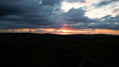 aerial footage of windfarm at sunset