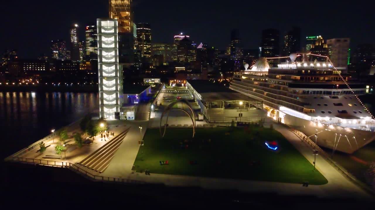 Large cruise ship docked at the port of Montreal, Canada. Aerial view at night