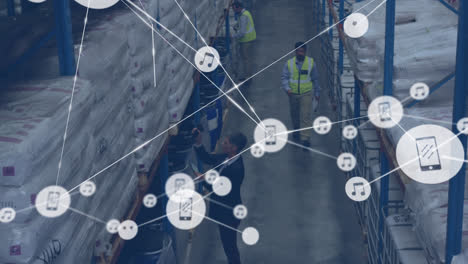 Animation-of-network-of-connections-with-icons-over-diverse-men-working-in-warehouse