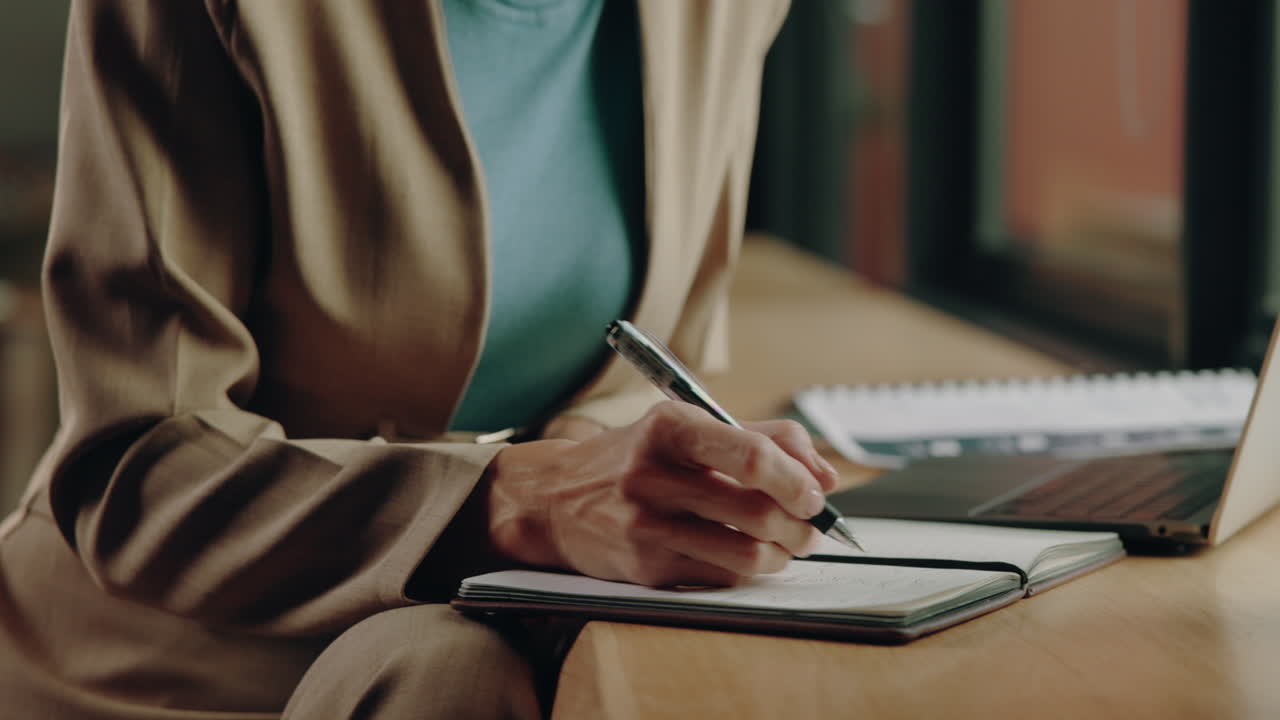 Woman working and writing in a notebook