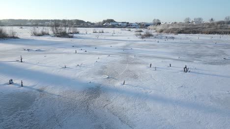 slow flight over a frozen-over lake in winter