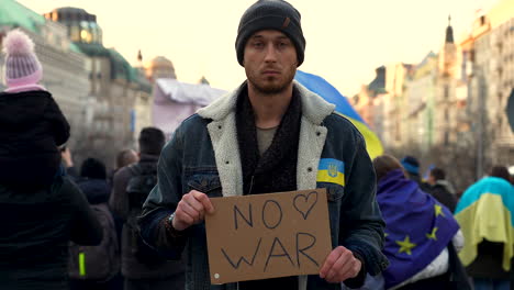 protester against war in ukraine with signboard, prague, slow motion