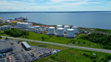 aerial view of an industrial port with storage tanks and logistics area by the sea