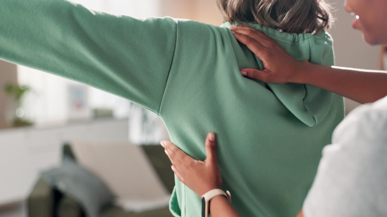 Physical therapist adjusting patient's back