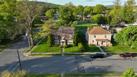 an establishing cinematic shot of a beautiful colonial style home with a well manicured lawn in america