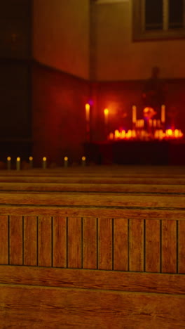 a view of the pews in a dimly lit church with candles lit on the altar