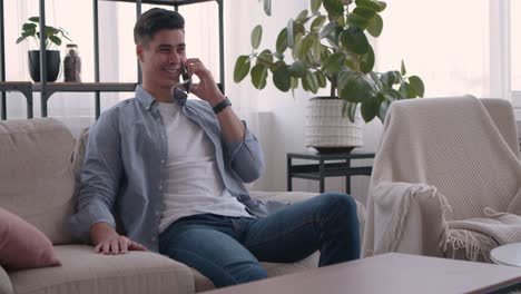 man talking on phone on couch