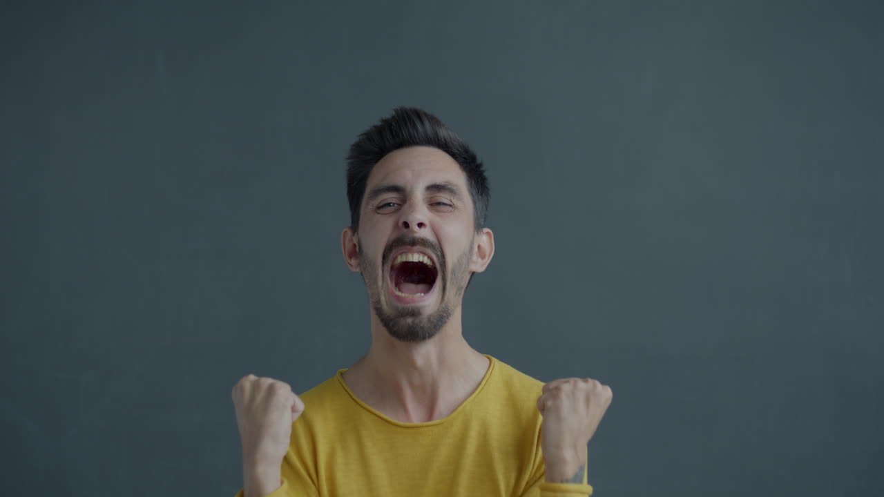 Man expressing various emotions, in a yellow shirt