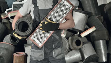 man holding variety of bus air filters.