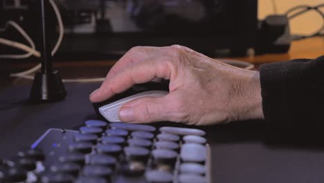 closeup of male hand using computer mouse at home desk