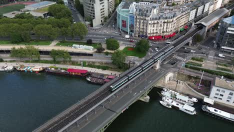 metropolitan public metro train crossing seine river on bridge of bir hakeim in paris, france