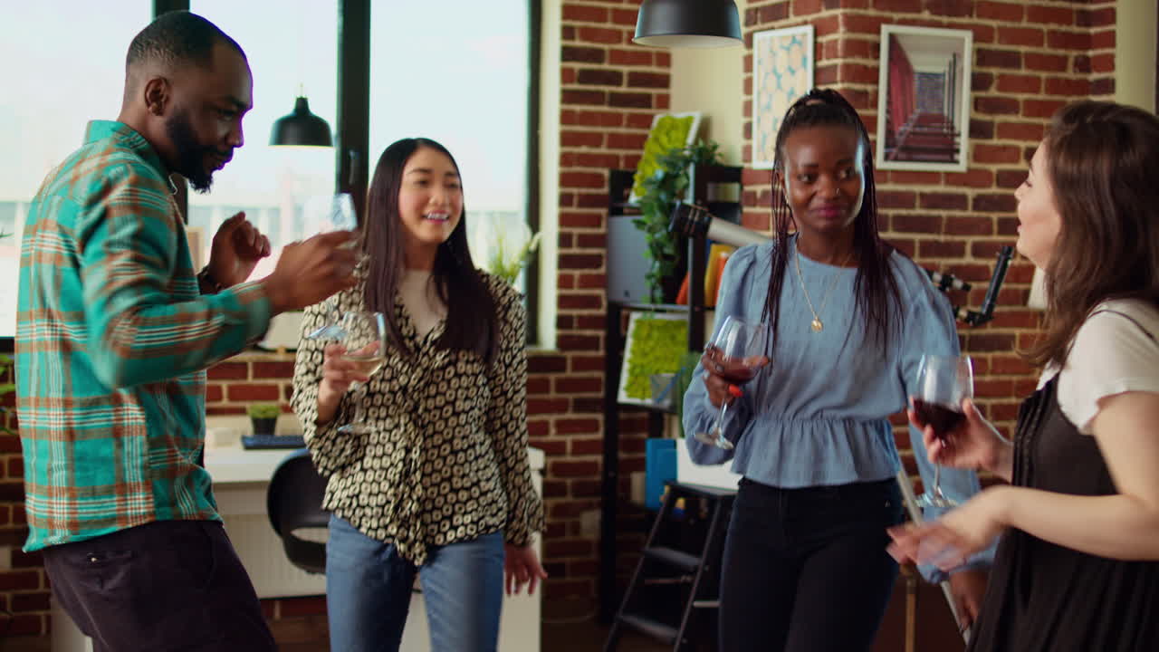 Group of friends dancing at apartment party, having fun together, moving their feet on rhythm