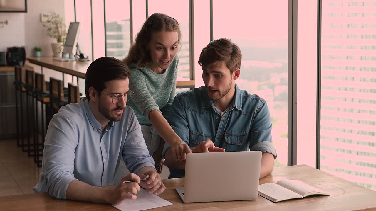 Smiling young female employee discussing online project presentation with colleagues.