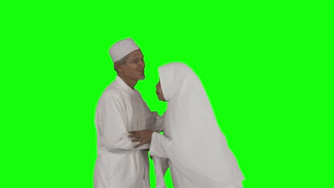 senior muslim man handshaking with his wife