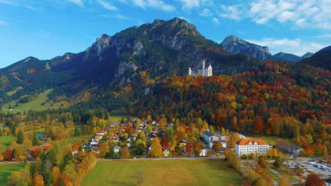 relaxing view of drone gliding over cars and trees in scenic autumn field in the afternoon near the neuschwanstein castle in germany, europe, wide view