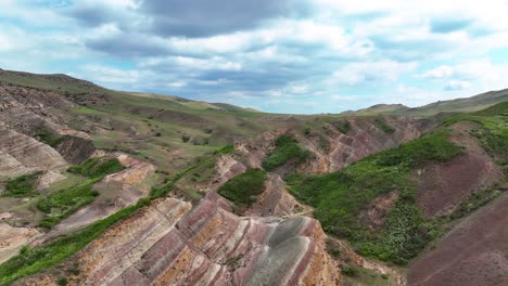 flight over colorful rainbow mountains near udabno, georgia - drone shot