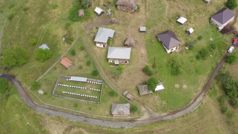 aerial shot rising up and circling a tiny remote village in serbia on the pester plateau