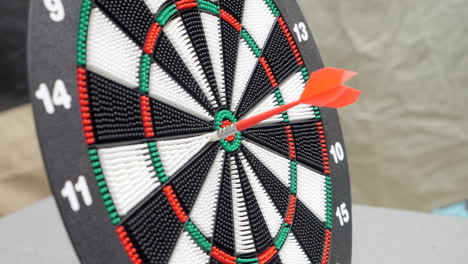 close up plastic outdoor dart thrown at board slow motion