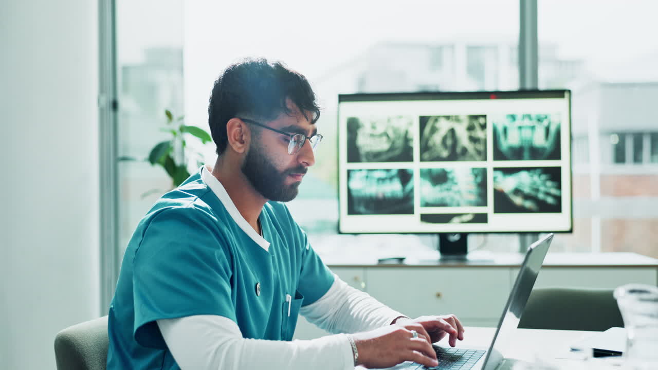 Doctor reviews X-rays on a laptop