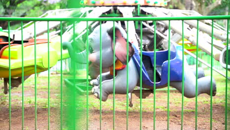 Wide-shot-of-a-ride-on-elephant-in-an-amusement-park