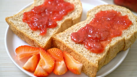 homemade whole wheat bread with strawberry jam and fresh strawberry