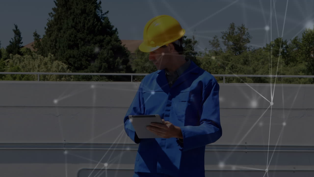 Animation of network of connections over caucasian engineer using tablet by solar panels
