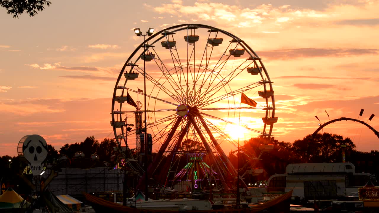 el lapso de tiempo el atardecer el carnaval la rueda de ferris