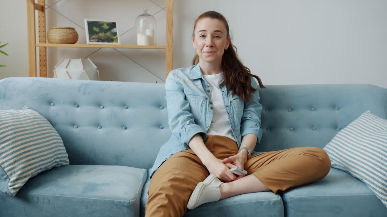 Woman Relaxing on Couch with Remote