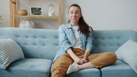 woman relaxing on couch with remote