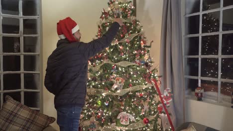 hispanic man decorating christmas tree