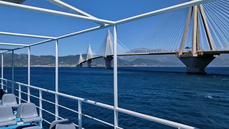 Ferry-Ride-Passing-Rio-Antirrio-Bridge-in-Greece,-Crossing-Gulf-of-Corinth