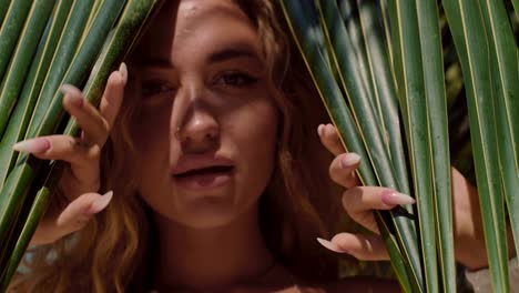 woman in palm leaves