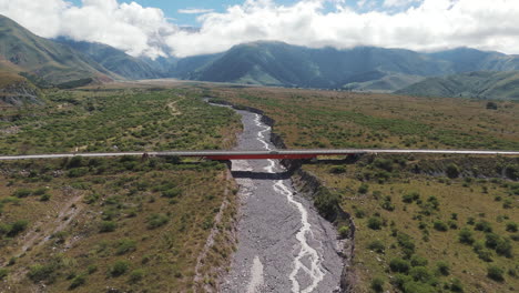 aerial shot approaching a beautiful bridge in jujuy, argentina, with a speeding car