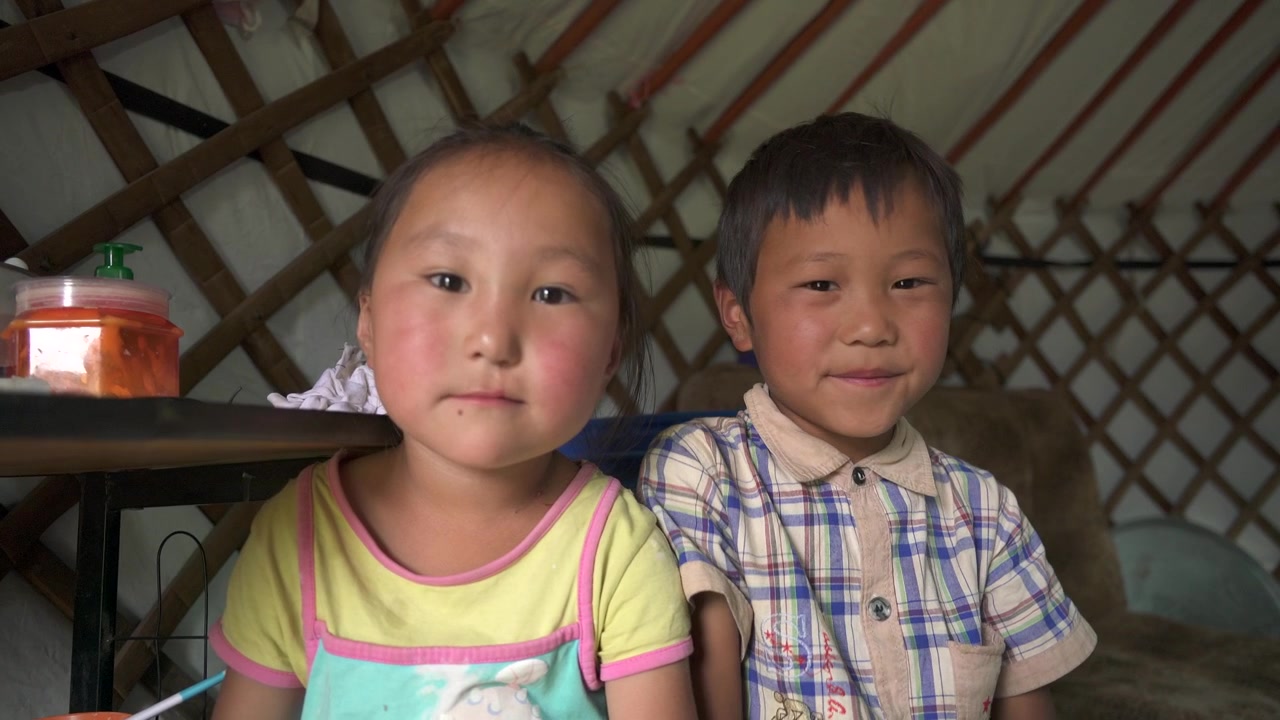 Dua Anak Muda Mongolia Duduk di Dalam Ger Tradisional