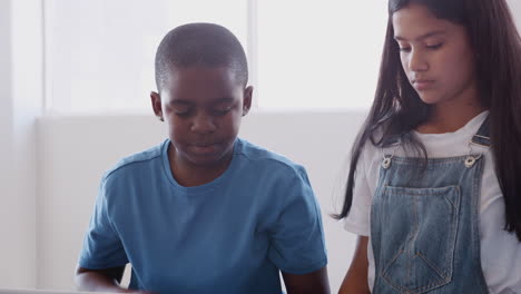 Male-And-Female-Students-Programing-Robot-Vehicle-In-After-School-Computer-Coding-Class