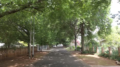 Slow-push-in-drone-shot-of-street-view-in-a-residential-area-of-Pretoria,-South-Africa