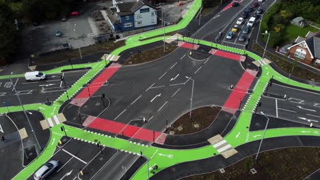 aerial view over vehicles travelling st helens cyclops traffic optimisation junction descending to crossroad intersection