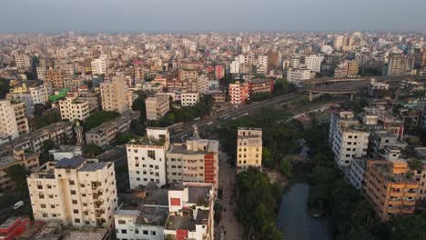 Aerial-View-Over-Dense-Metropolitan-Cityscape-Condominiums-With-Highway-Running-Past