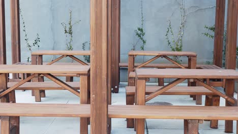 empty wooden tables and benches on a patio