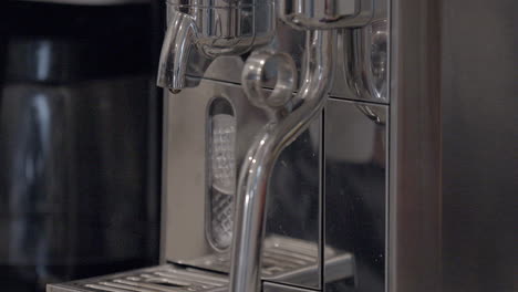 a white espresso cup is placed on an espresso machine for a shot of espresso