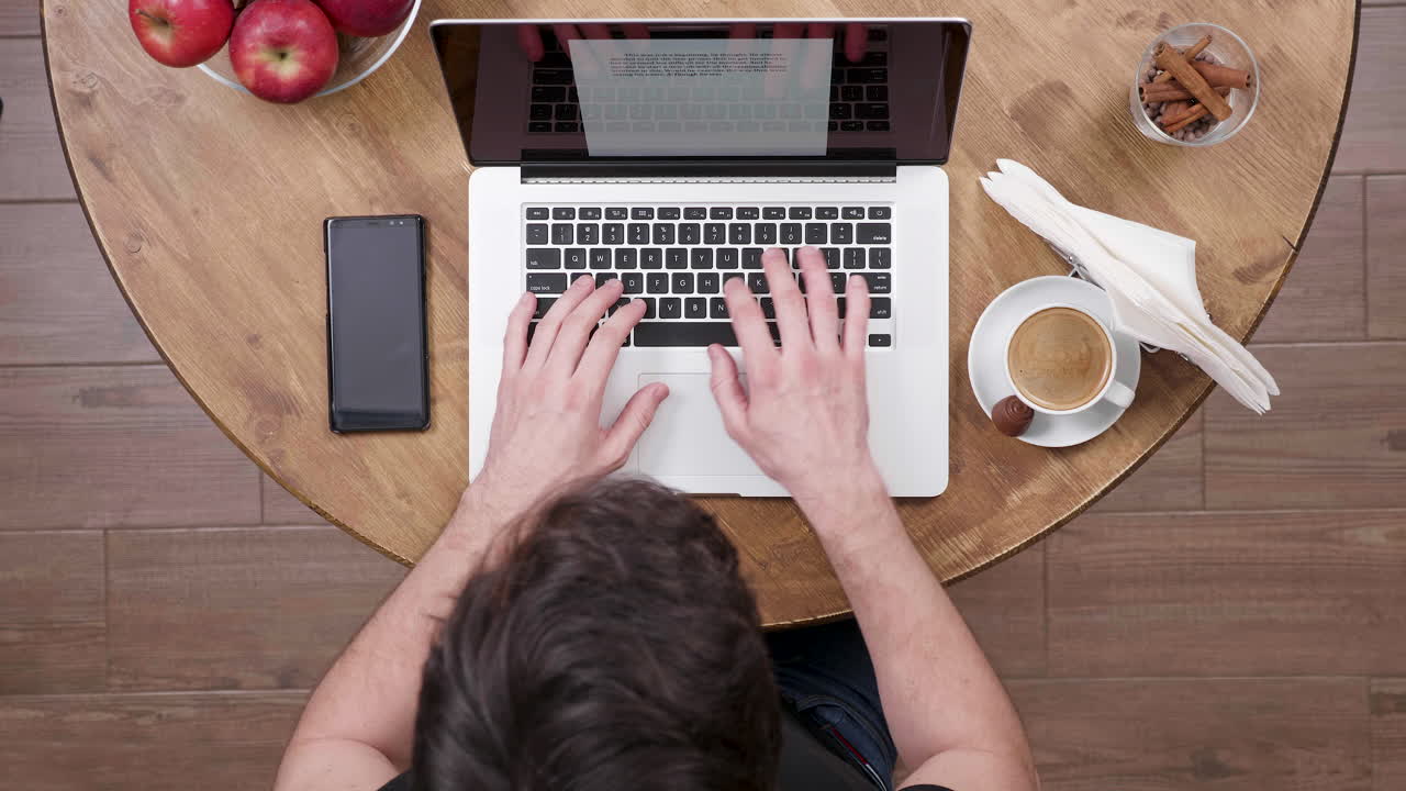 Person working on a laptop at a desk