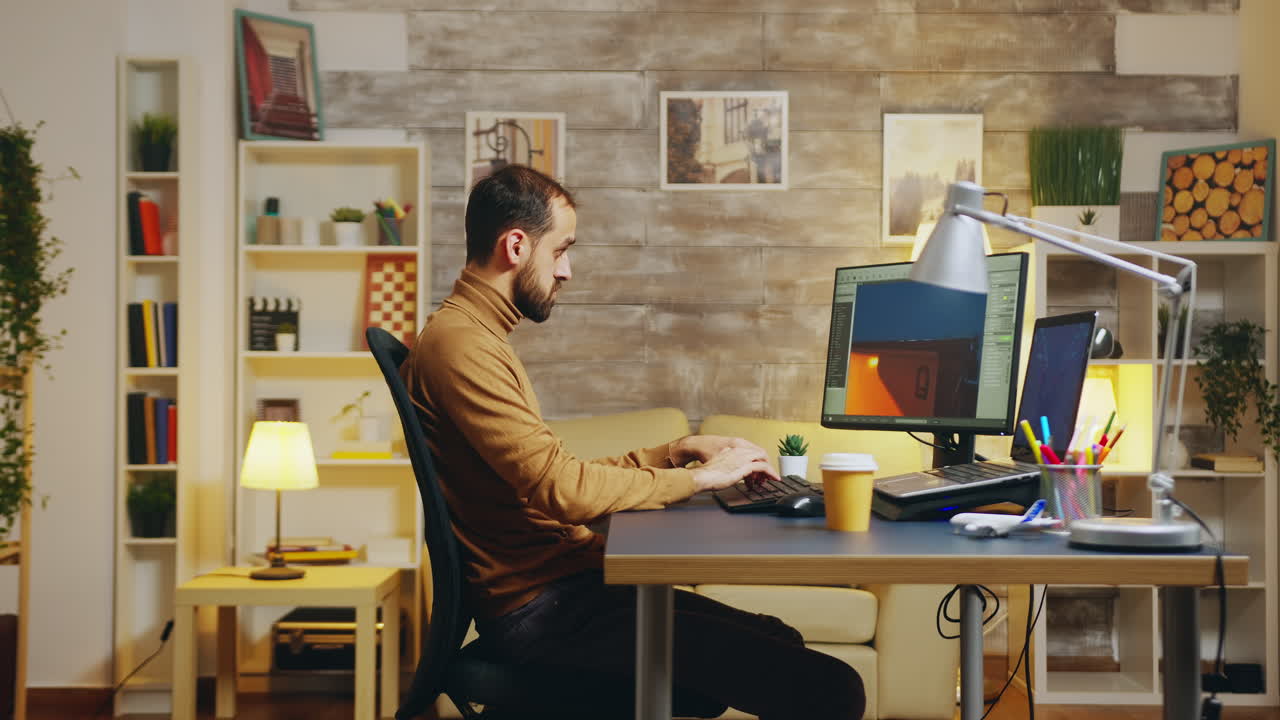 Side view of game developer working from home office